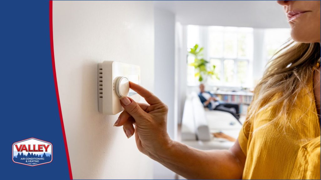 A homeowner adjusting the thermostat.