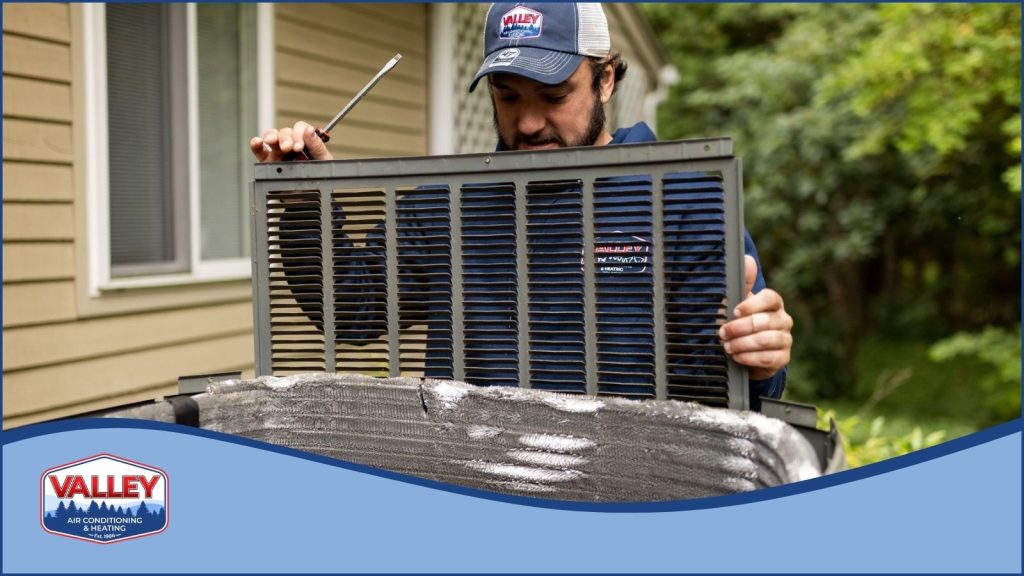 A valley air HVAC technician servicing an AC condenser unit