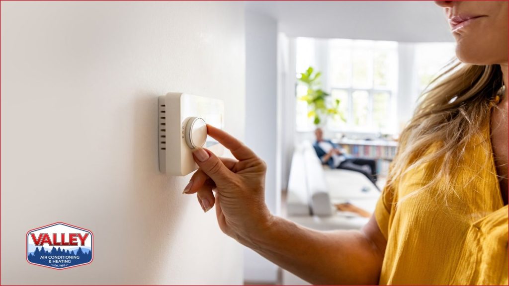 A homeowner adjusting a smart thermostat.